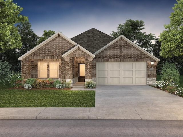 view of front of property featuring a yard and a garage