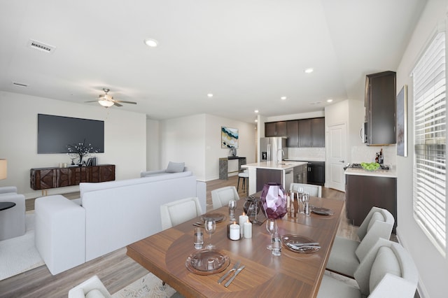 dining space featuring ceiling fan, light hardwood / wood-style floors, and a wealth of natural light