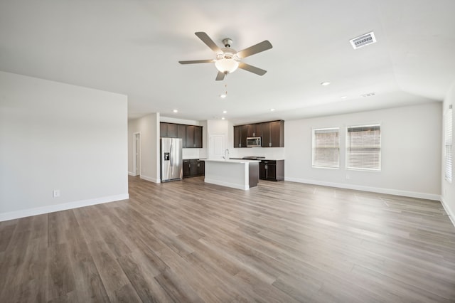 unfurnished living room with ceiling fan and hardwood / wood-style flooring