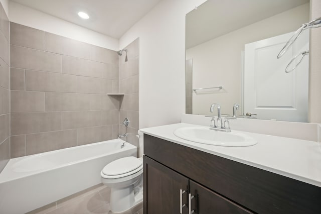 full bathroom featuring tile patterned flooring, toilet, vanity, and tiled shower / bath