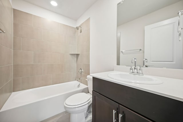 full bathroom with vanity, toilet, and tiled shower / bath