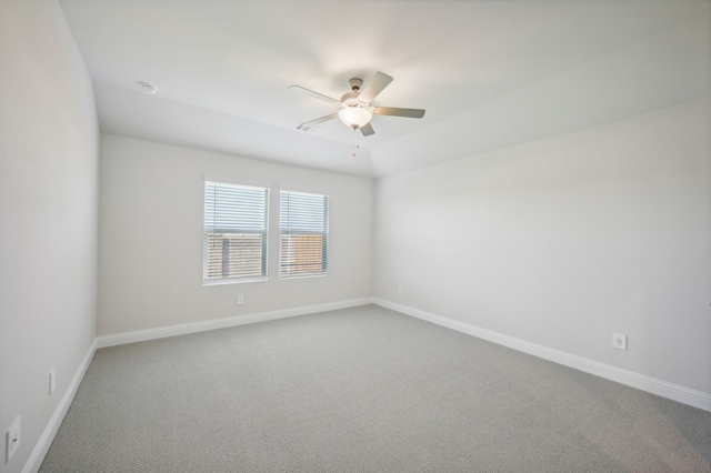 empty room featuring carpet flooring and ceiling fan