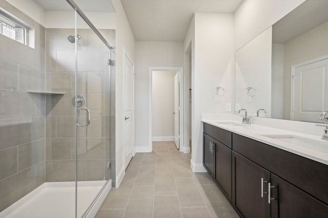 bathroom featuring tile patterned flooring, vanity, and an enclosed shower