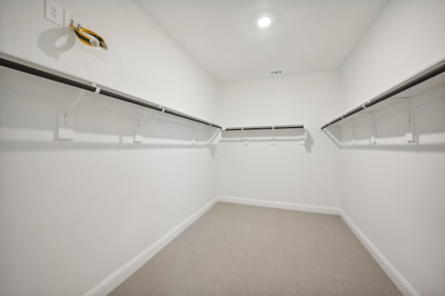 walk in closet with carpet