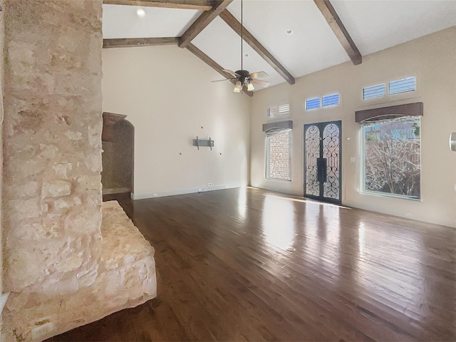 unfurnished living room featuring high vaulted ceiling, beam ceiling, and ceiling fan