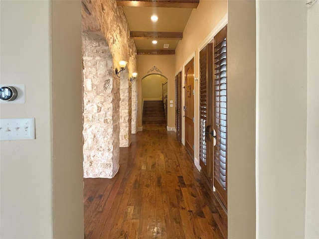 hall with beamed ceiling and dark hardwood / wood-style floors