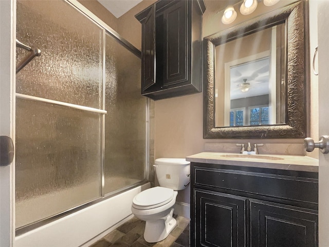 full bathroom featuring toilet, vanity, and combined bath / shower with glass door