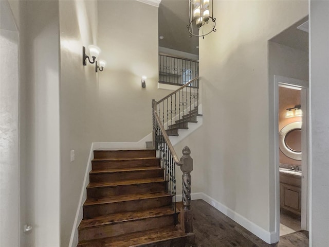 staircase featuring a notable chandelier and hardwood / wood-style floors