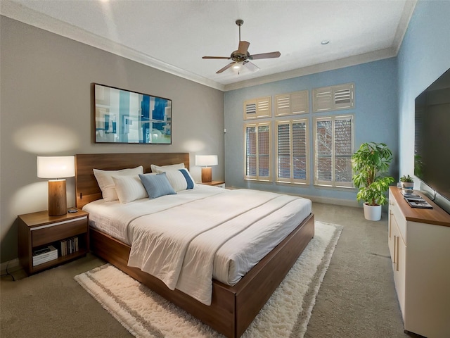 carpeted bedroom featuring ceiling fan and crown molding