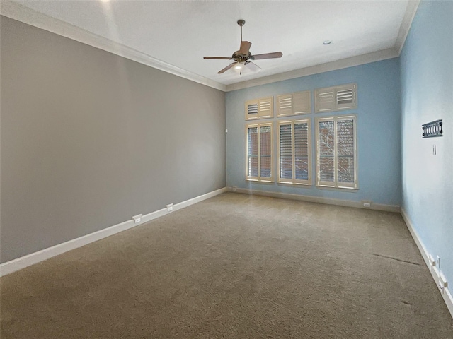 carpeted empty room featuring ceiling fan and crown molding