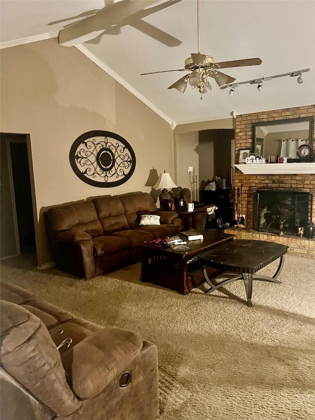 carpeted living room with ornamental molding, ceiling fan, lofted ceiling with beams, and a fireplace