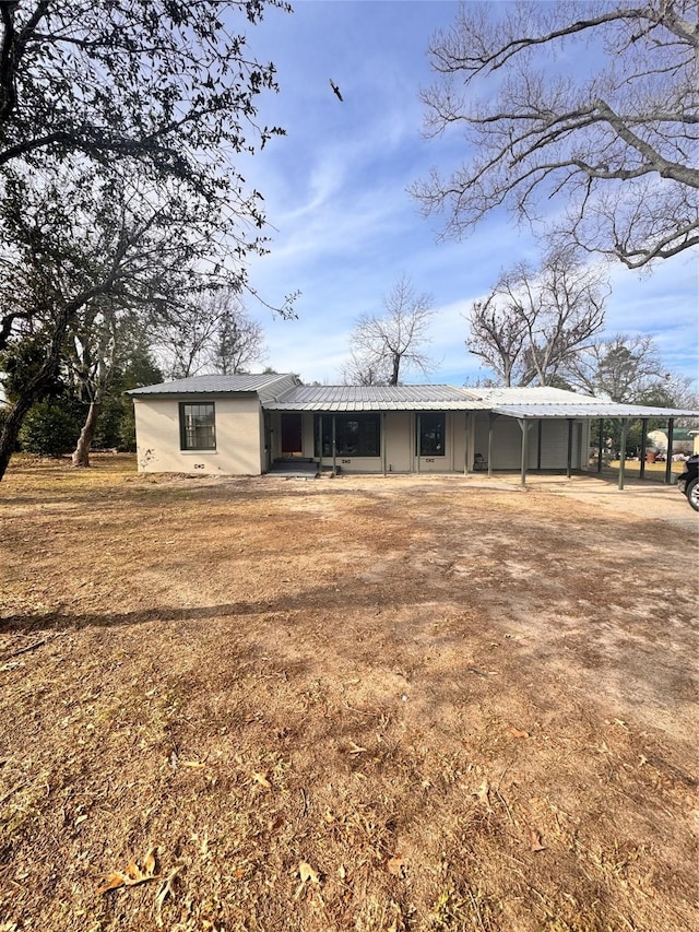 back of property with a carport