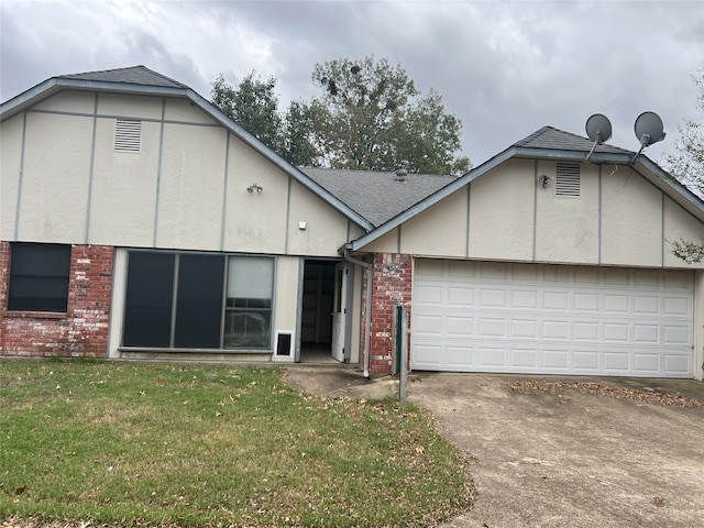 view of front of home with a garage and a front lawn