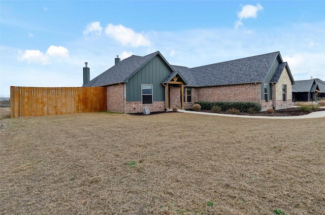 ranch-style home with a shingled roof, board and batten siding, and brick siding