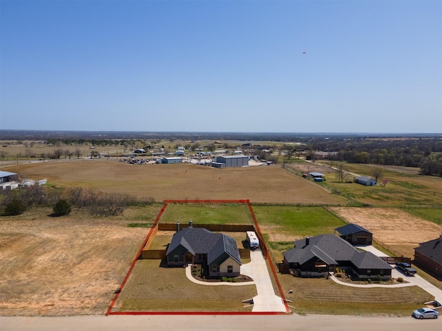 birds eye view of property with a rural view