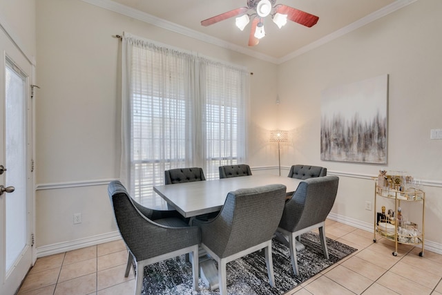 dining area featuring ceiling fan, crown molding, light tile patterned floors, and a healthy amount of sunlight