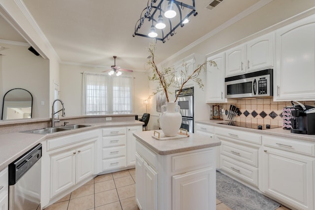 kitchen featuring white cabinetry, sink, a kitchen island, and appliances with stainless steel finishes