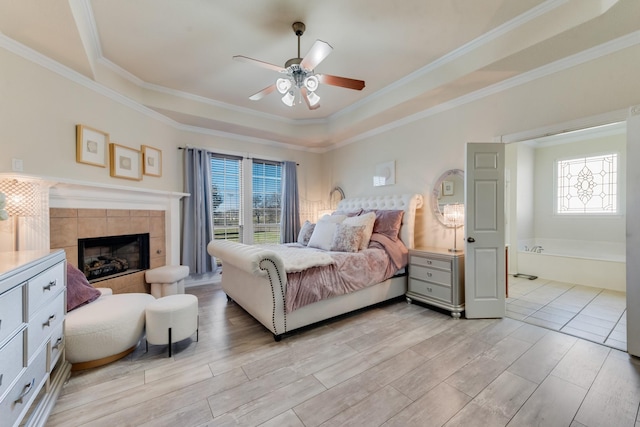 bedroom featuring ceiling fan, a fireplace, and crown molding