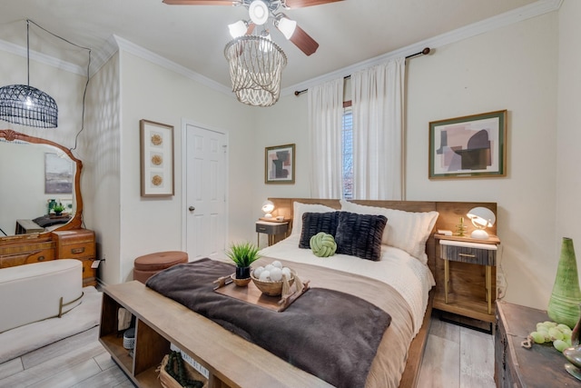 bedroom featuring ceiling fan with notable chandelier, light hardwood / wood-style flooring, and ornamental molding