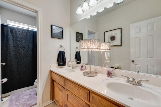 bathroom featuring tile patterned floors, vanity, and toilet