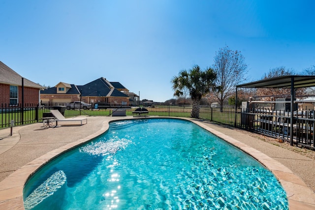 view of pool with a lawn and a patio area