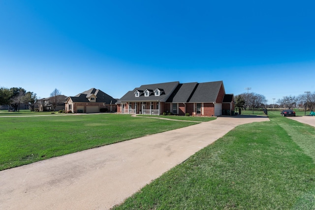 view of front facade with brick siding and a front yard