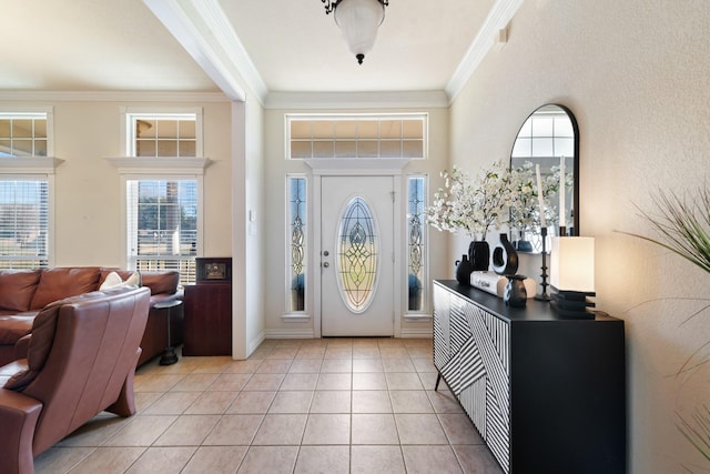 tiled foyer entrance with plenty of natural light and ornamental molding