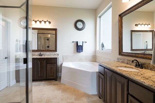 bathroom featuring vanity, tile patterned flooring, and plus walk in shower