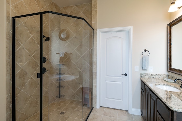 bathroom featuring an enclosed shower, vanity, and tile patterned floors