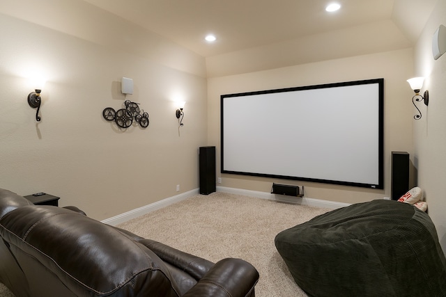 carpeted cinema with lofted ceiling