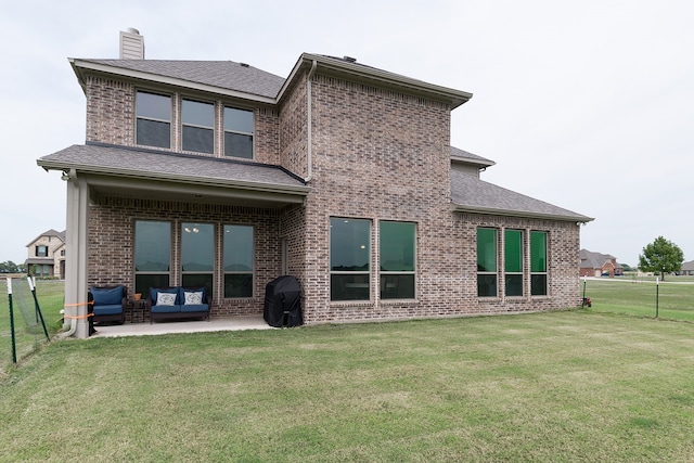 back of house with a lawn, outdoor lounge area, and a patio area