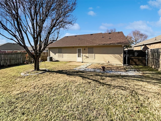 rear view of property featuring a patio, central air condition unit, and a yard