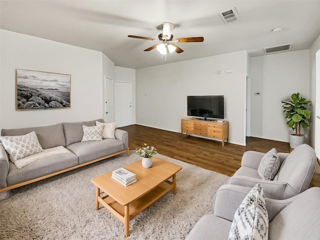 living room with ceiling fan and hardwood / wood-style floors