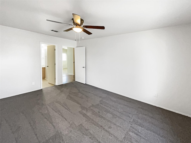 carpeted spare room with ceiling fan