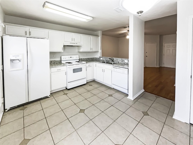 kitchen featuring white appliances, light stone countertops, white cabinets, ceiling fan, and sink