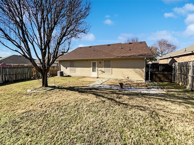 back of house featuring a patio, a yard, and central AC