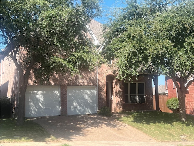 view of front facade with a front yard and a garage