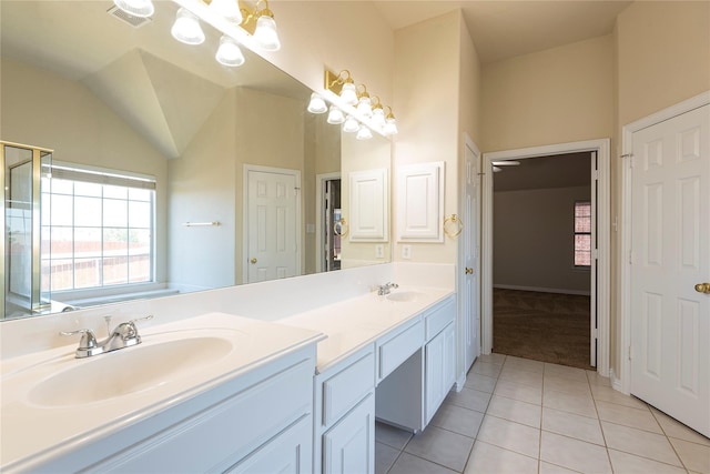 bathroom featuring vanity, vaulted ceiling, and tile patterned floors