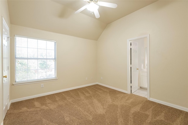 carpeted spare room with vaulted ceiling and ceiling fan