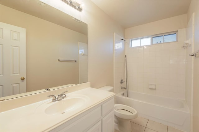 full bathroom with tile patterned floors, toilet, tiled shower / bath combo, and vanity