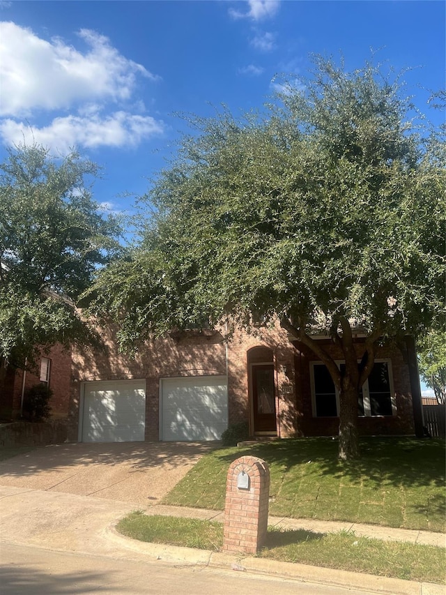 view of front of home with a front lawn and a garage