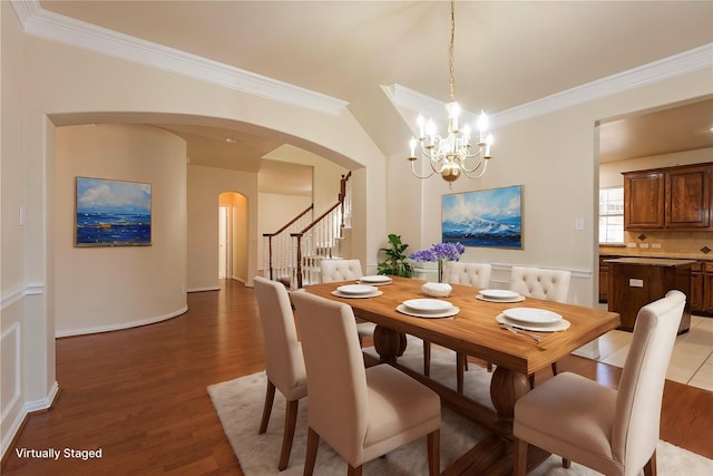 dining space with crown molding and hardwood / wood-style flooring