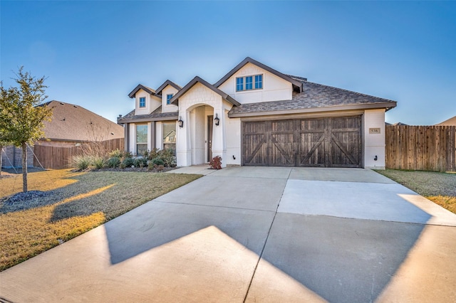 view of front of property featuring a garage and a front lawn