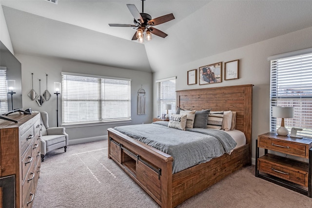 bedroom with ceiling fan, lofted ceiling, light carpet, and multiple windows