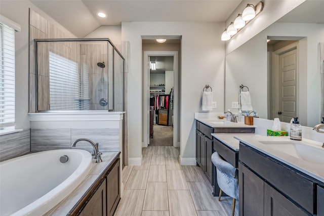 bathroom with separate shower and tub, vanity, a healthy amount of sunlight, and lofted ceiling