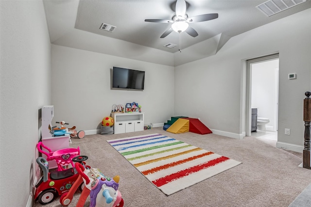 game room with carpet flooring, a tray ceiling, ceiling fan, and lofted ceiling