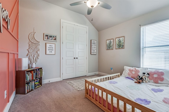 carpeted bedroom with multiple windows, ceiling fan, a closet, and lofted ceiling