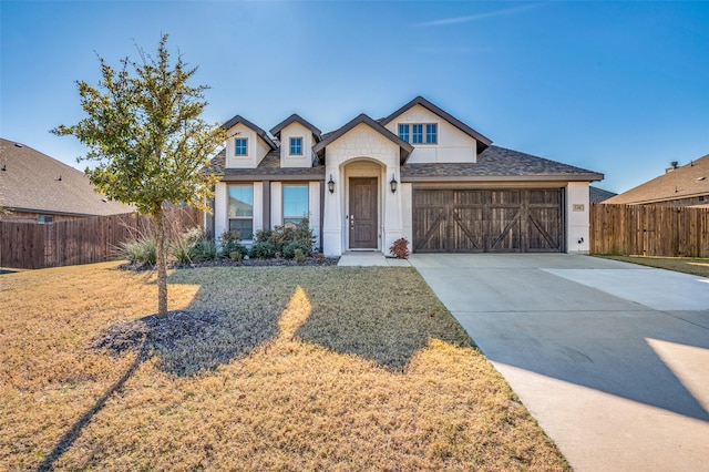 view of front of house with a front yard and a garage