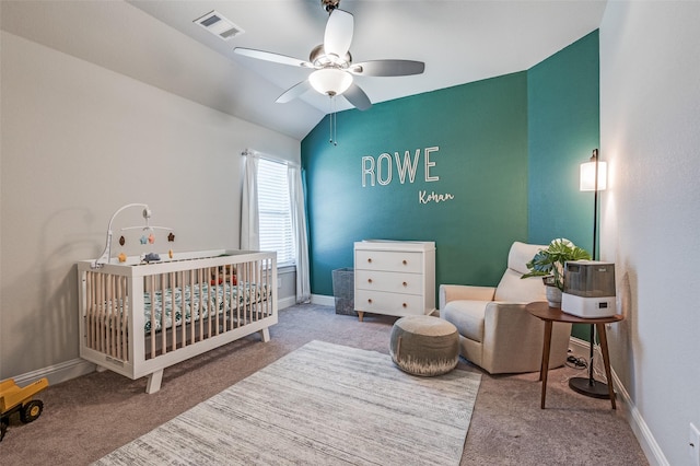 bedroom featuring carpet, ceiling fan, lofted ceiling, and a nursery area