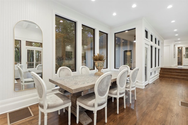 dining room featuring dark hardwood / wood-style floors and crown molding